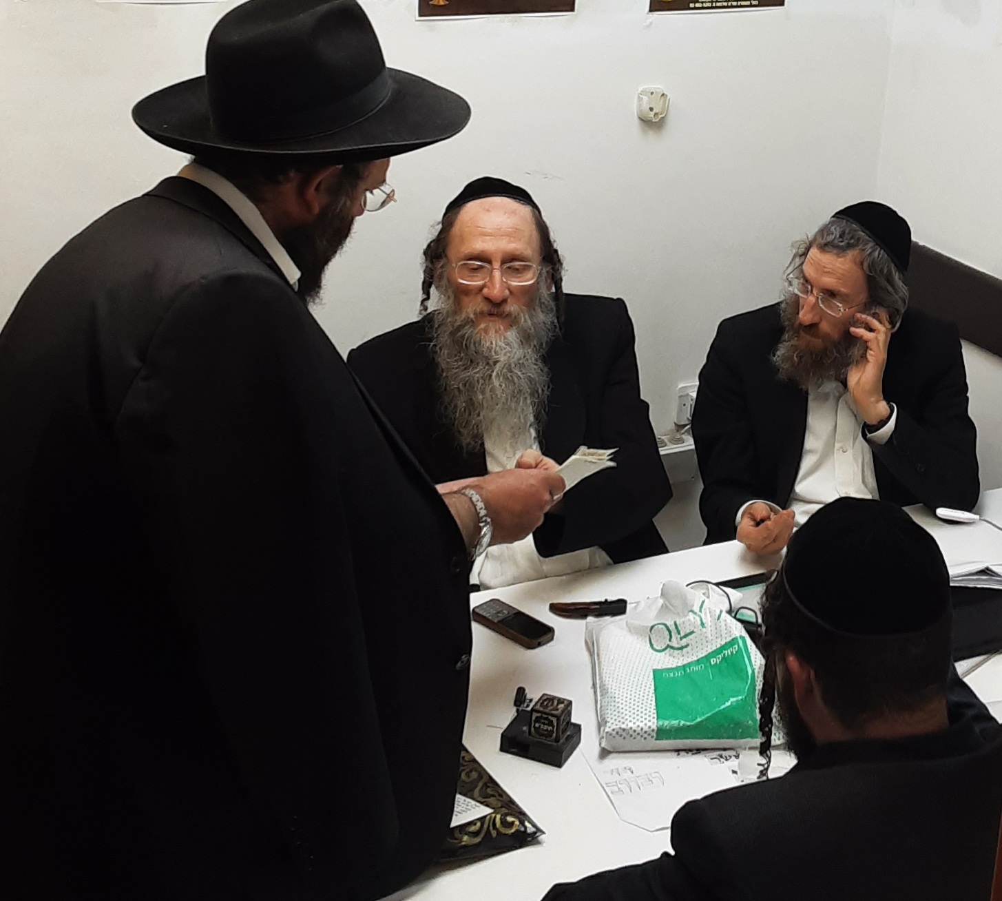 Rabbonim reviewing Sta"m items